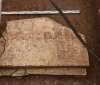 Надгробные плиты инока Феодосия: сверху плита эпохи Ивана Грозного, из-под нее виден край ранней плиты